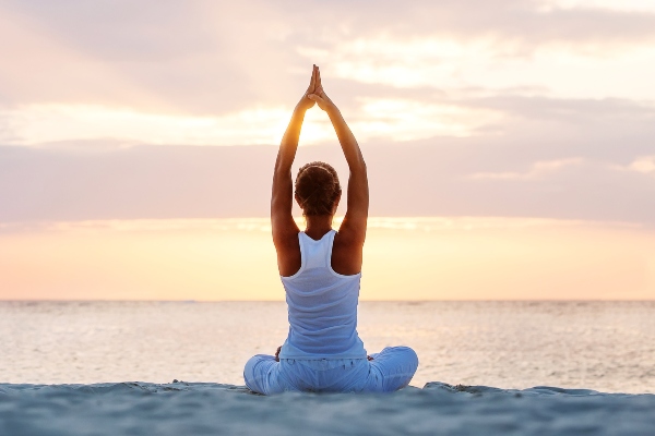 Practicando yoga frente al mar